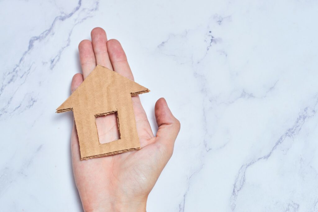 Cardboard house, homeless housing and home protecting insurance concept